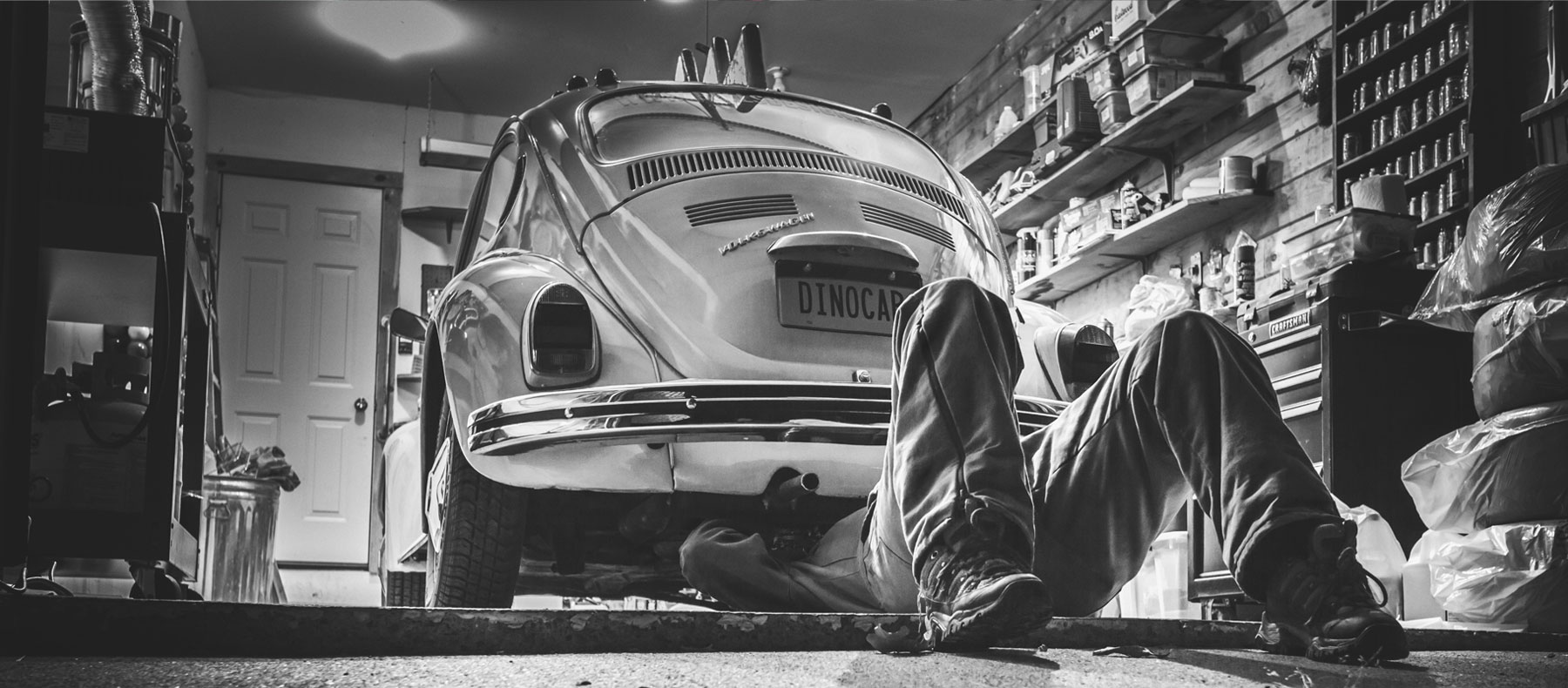 Man under car performing maintenance