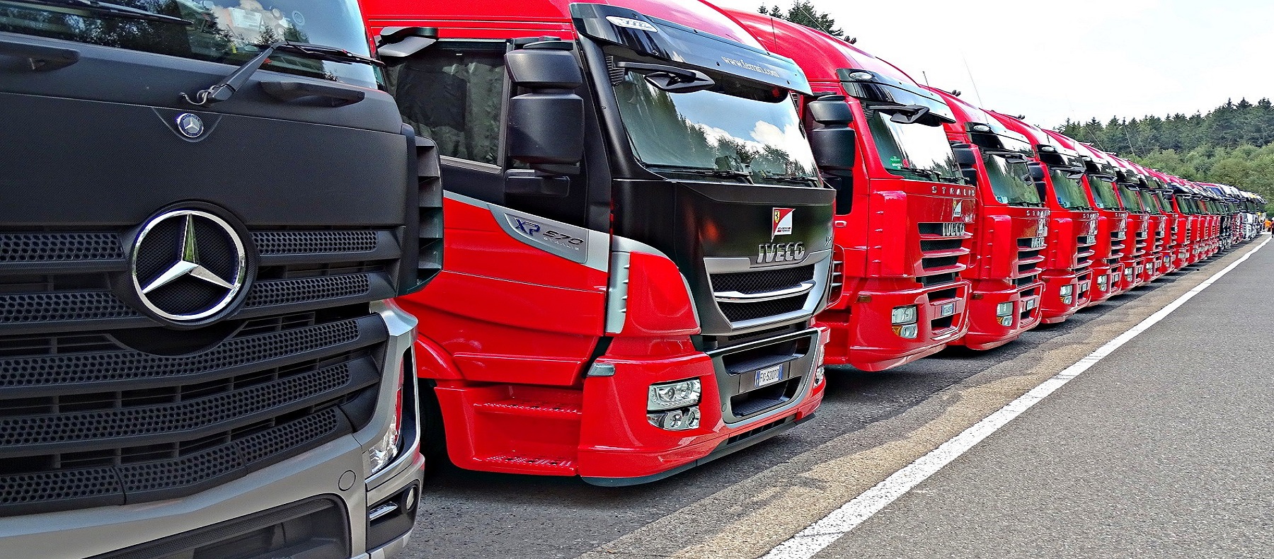 A fleet of red and black trucks parked in a lot