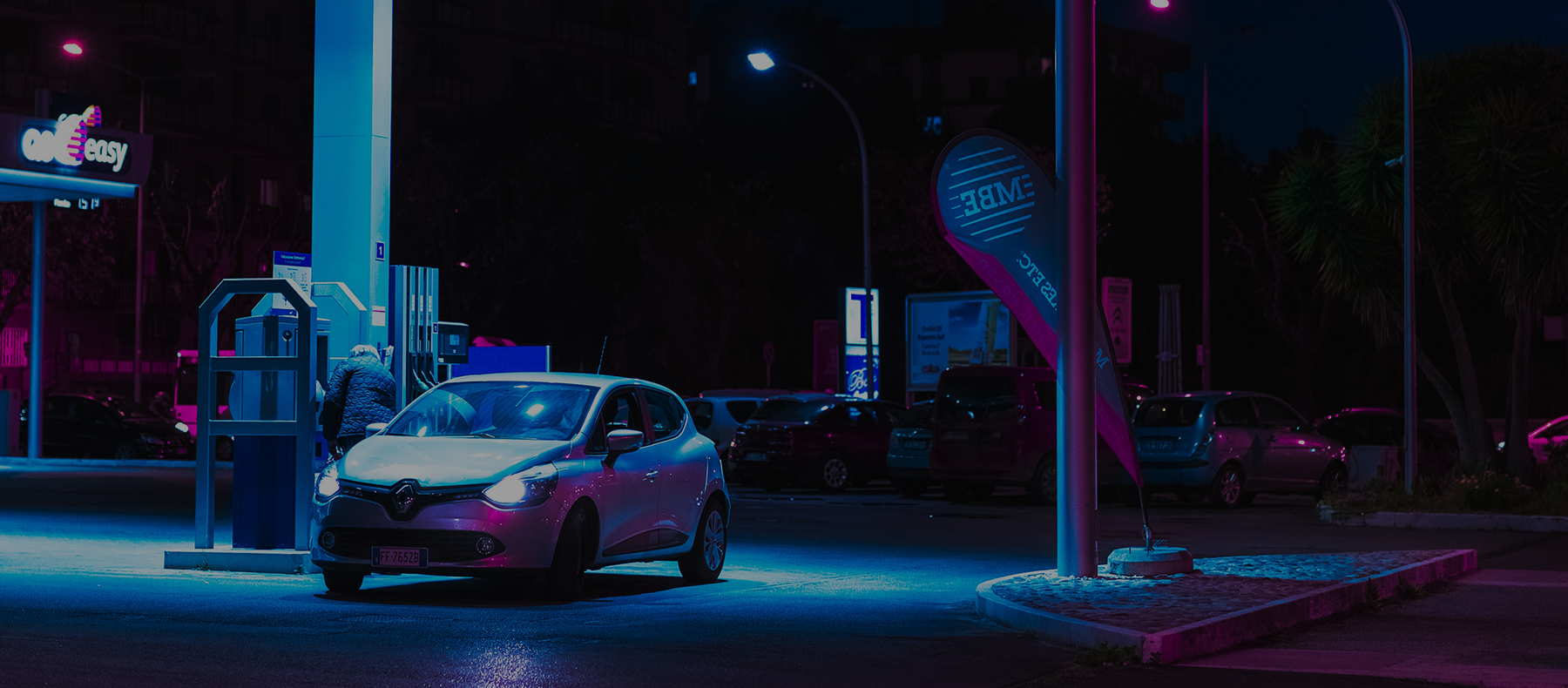 Car parked in a petrol station at night